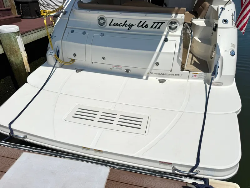 Slide: The Image of The image shows the stern of a 2017 Sea Ray Sundancer 350 Coupe, docked at a pier. - 4