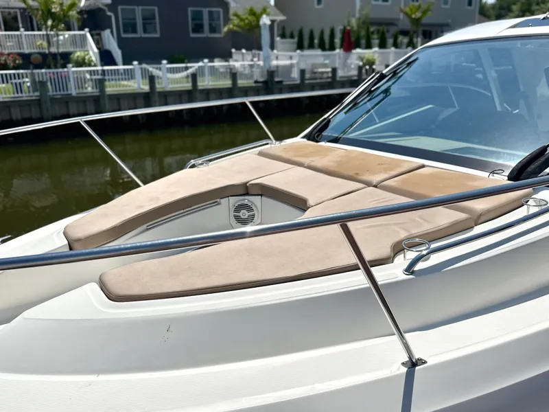 Slide: The Image of The image shows the foredeck of a 2017 Sea Ray Sundancer 350 Coupe with sun pads. - 19