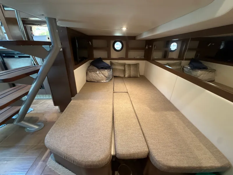 Slide: The Image of Interior of the Sea Ray Sundancer 350 Coupe with cozy seating area and stairs. - 35
