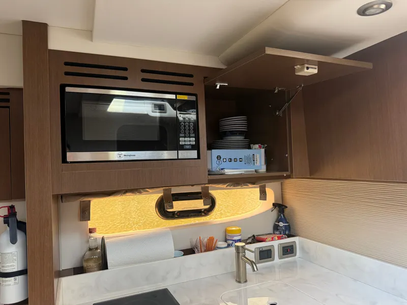 Slide: The Image of Interior of a Sea Ray Sundancer 350 Coupe with microwave and cabinets. - 26
