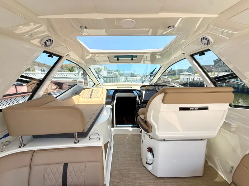 Slide: The Image of Interior of a Sea Ray Sundancer 350 Coupe with beige seating and panoramic roof. - 13