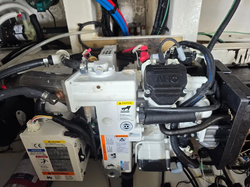 Slide: The Image of Engine compartment of a 2017 Sea Ray Sundancer 350 Coupe with various hoses and cables. - 45