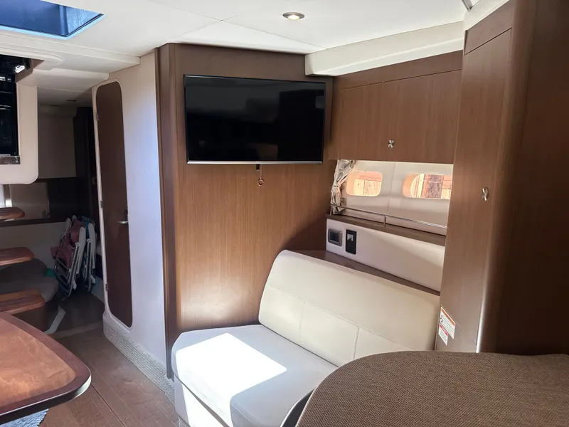 Slide: The Image of Interior of the 2017 Sea Ray Sundancer 350 Coupe with sofa and TV. - 30