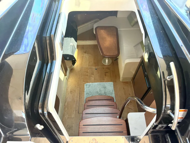 Slide: The Image of Interior of the 2017 Sea Ray Sundancer 350 Coupe with wood flooring and seating area. - 20