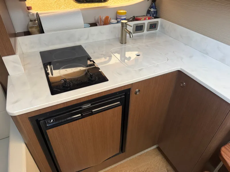 Slide: The Image of Compact kitchenette with stove, sink, and fridge in a boat. - 23