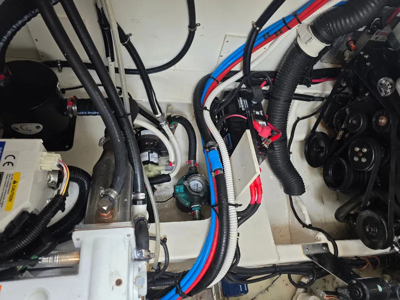 Slide: The Image of Engine compartment of the 2017 Sea Ray Sundancer 350 Coupe with cables and hoses. - 42