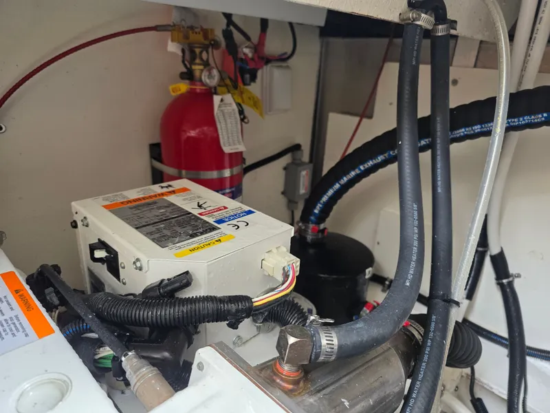 Slide: The Image of View of the engine compartment in a 2017 Sea Ray Sundancer 350 Coupe with fire extinguisher and hoses. - 47