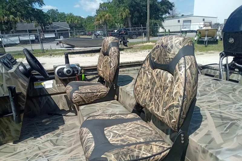 Slide: The Image of 2025 Lund 1760 Predator SC boat with camo seats and steering console. - 24