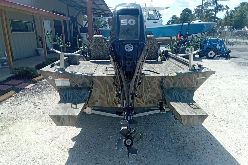 Slide: The Image of 2025 Lund 1760 Predator SC boat with camouflage design and Mercury 50 outboard motor. - 21