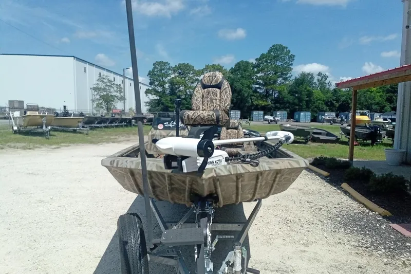 Slide: The Image of 2025 Lund 1760 Predator SC boat on trailer, camo design, outdoor setting. - 8