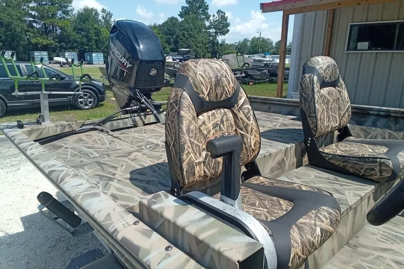 Slide: The Image of 2025 Lund 1760 Predator SC boat with camo seats and Mercury outboard motor. - 16