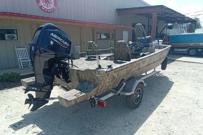 Slide: The Image of 2025 Lund 1760 Predator SC boat with Mercury engine, parked outside a building. - 20