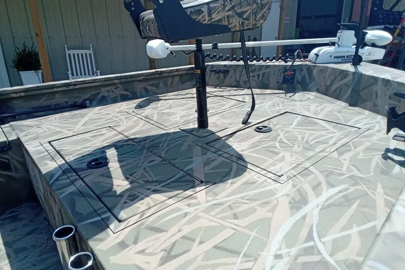 Slide: The Image of 2025 Lund 1760 Predator SC boat deck with camo pattern and Minn Kota trolling motor. - 15