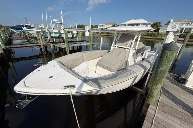Slide: The Image of 2023 Seafox 268 boat docked at marina, featuring sleek design and covered seating. - 15
