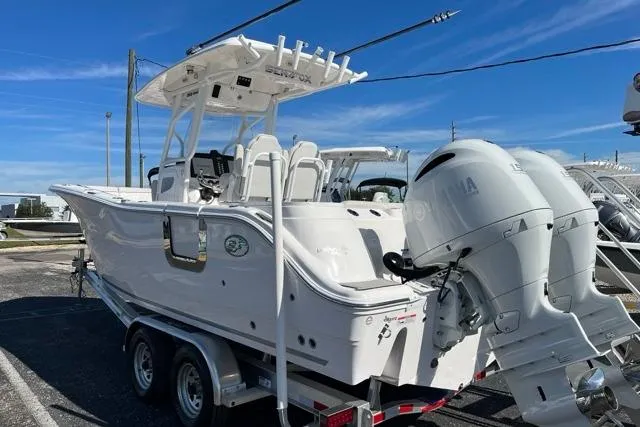 Slide: The Image of 2023 Seafox 268 boat on trailer with dual outboard engines, parked outdoors. - 2