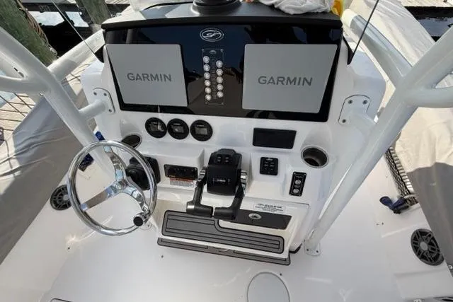Slide: The Image of 2023 Seafox 268 boat dashboard with dual Garmin displays and steering wheel. - 21