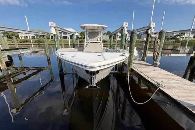 Slide: The Image of 2023 Seafox 268 boat docked at marina, reflecting on calm water. - 16