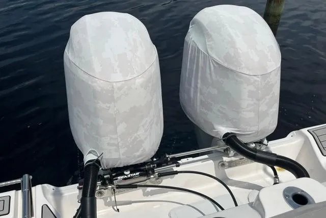 Slide: The Image of Twin outboard motors on a 2023 Seafox 268 boat, covered and docked. - 10