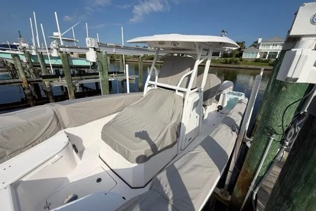 Slide: The Image of 2023 Seafox 268 boat docked, covered, with clear blue sky background. - 19
