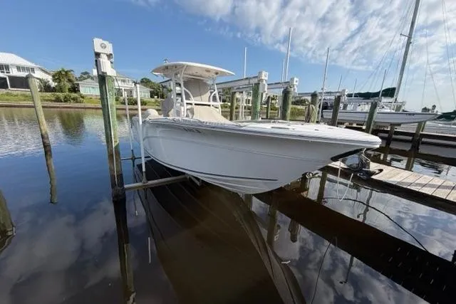 Slide: The Image of 2023 Seafox 268 boat docked in a marina under a partly cloudy sky. - 18