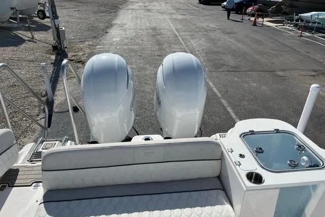 Slide: The Image of 2023 Seafox 268 boat with dual outboard engines and seating area. - 6