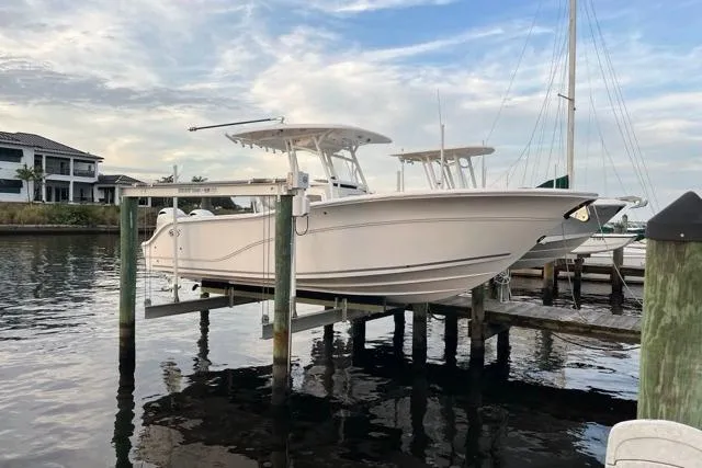 The Image of 2023 Seafox 268 boat docked on a lift by the waterfront. - 0