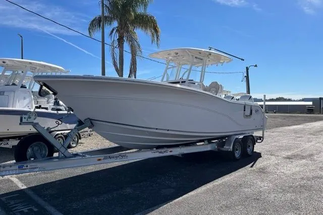 Slide: The Image of 2023 Seafox 268 boat on trailer, parked outdoors under clear blue sky. - 1