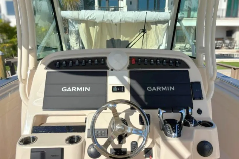 Slide: The Image of Helm of 2025 Grady-White Canyon 336 with Garmin navigation displays and controls. - 15