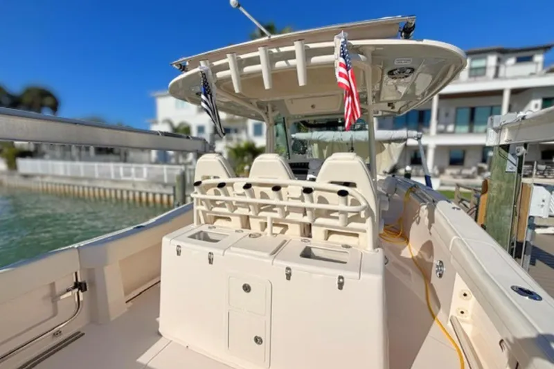 Slide: The Image of 2025 Grady-White Canyon 336 boat docked, featuring spacious seating and modern amenities. - 17