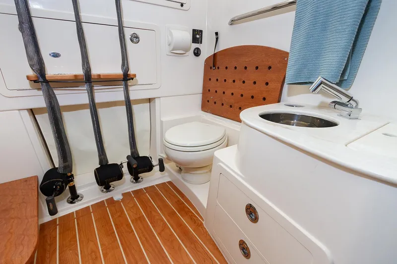 Slide: The Image of Manufacturer Provided Image: 2025 Grady-White Canyon 336 boat bathroom with wooden flooring and modern fixtures. - 10