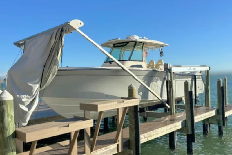 Slide: The Image of 2025 Grady-White Canyon 336 boat docked on a sunny day. - 13