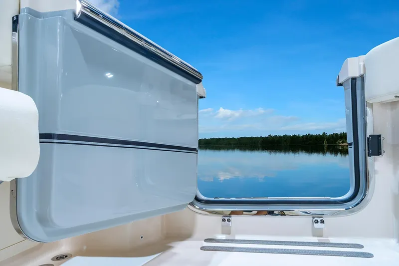 Slide: The Image of Manufacturer Provided Image: 2025 Grady-White Canyon 336 boat with open side door, overlooking serene water and blue sky. - 3
