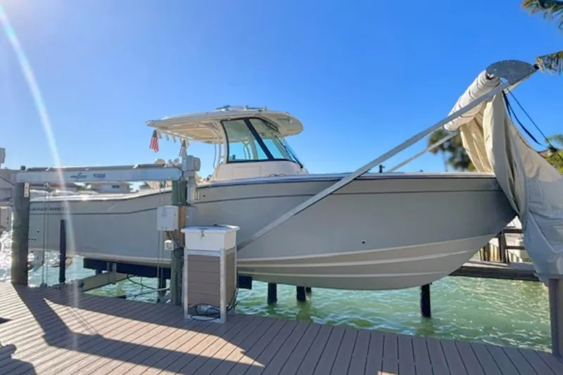 Slide: The Image of 2025 Grady-White Canyon 336 boat docked under clear blue sky. - 12