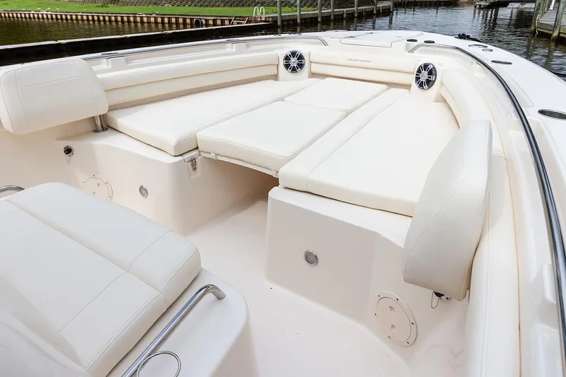 Slide: The Image of Manufacturer Provided Image: 2025 Grady-White Canyon 336 boat interior with white cushioned seating and speakers. - 4