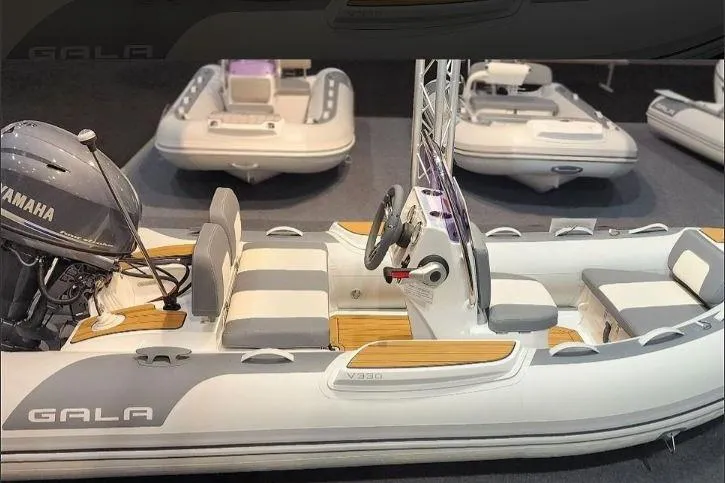 Slide: The Image of 2026 Gala VIKING V330H inflatable boat with Yamaha engine, showcased indoors. - 9