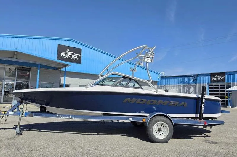 Slide: The Image of 1998 Moomba Outback boat on trailer, parked outside Prestige Water Sports building. - 3
