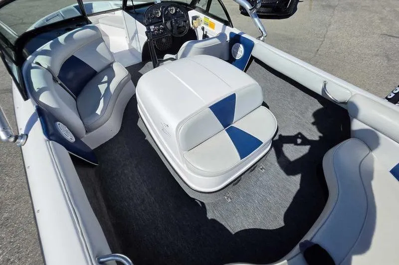 Slide: The Image of 1998 Moomba Outback boat interior with blue and white seating and steering console. - 9