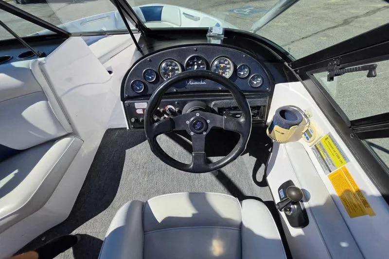 Slide: The Image of 1998 Moomba Outback boat cockpit with steering wheel and instrument panel. - 14