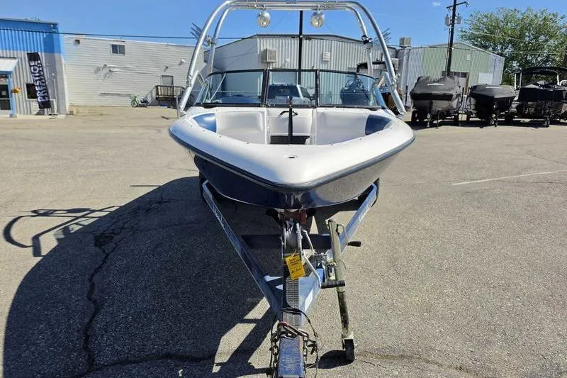 Slide: The Image of 1998 Moomba Outback boat on trailer in parking lot, front view. - 1