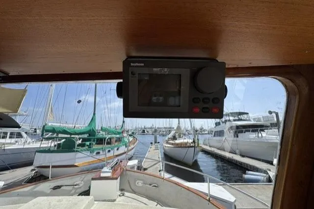 Slide: The Image of 1977 Californian 38 Motor Yacht interior view with navigation equipment, docked at marina. - 11