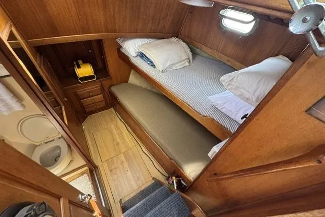 Slide: The Image of 1977 Californian 38 Motor Yacht cabin with wooden interior, bunk beds, and compact bathroom. - 16