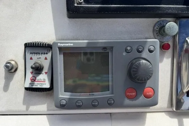 Slide: The Image of Control panel of a 1977 Californian 38 Motor Yacht featuring Raymarine equipment. - 49