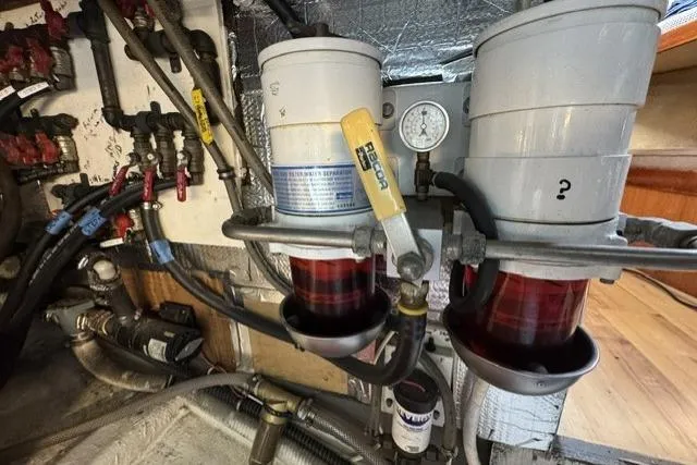 Slide: The Image of Engine room of a 1977 Californian 38 Motor Yacht with fuel filters and gauges. - 24