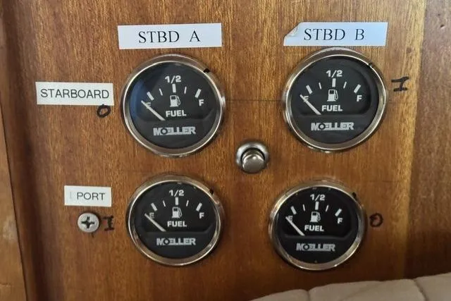 Slide: The Image of Fuel gauges on a 1977 Californian 38 Motor Yacht dashboard, labeled for starboard and port sides. - 38