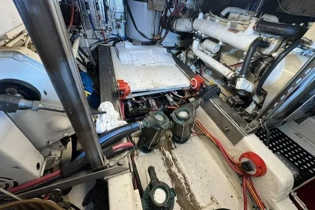 Slide: The Image of Engine room of a 1977 Californian 38 Motor Yacht, showcasing mechanical components and wiring. - 30