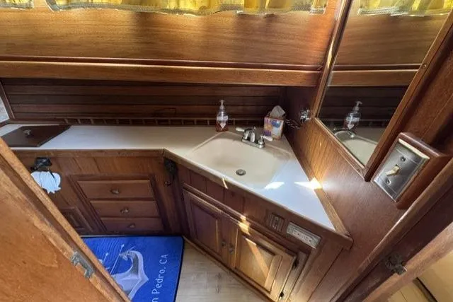 Slide: The Image of 1977 Californian 38 Motor Yacht bathroom with wooden cabinetry and countertop sink. - 35