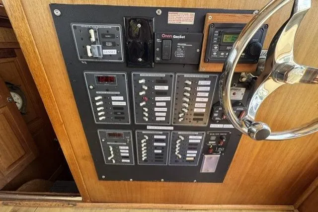 Slide: The Image of 1977 Californian 38 Motor Yacht control panel with switches and steering wheel. - 5