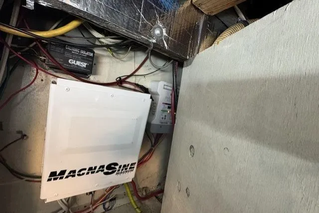 Slide: The Image of Electrical components inside a 1977 Californian 38 Motor Yacht, featuring a MagnaSine inverter. - 28
