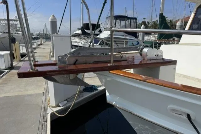 Slide: The Image of 1977 Californian 38 Motor Yacht docked at marina with visible anchor and railing. - 3