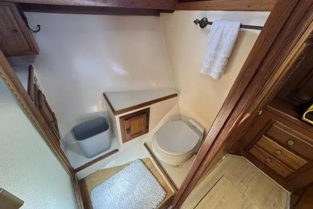 Slide: The Image of 1977 Californian 38 Motor Yacht bathroom with wooden cabinetry and compact design. - 17